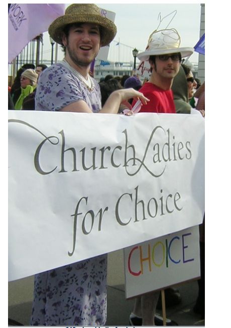 Photo shows two guys dressed up as women carrying a banner which reads, "Church ladies for choice."