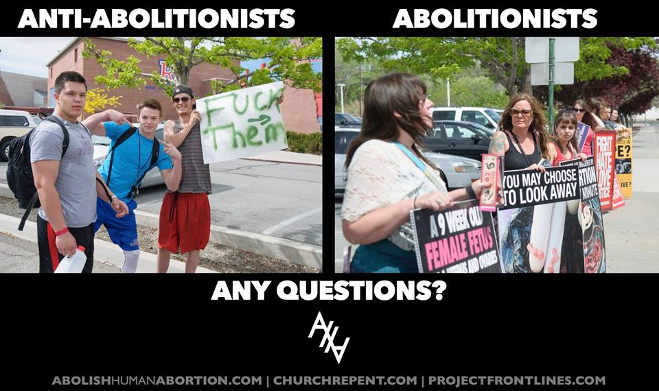 A group of pro-lifers from the Abolish Human Abortion were on the street holding some graphic abortion pictures where three young boys are standing next to them holding a sign that says "F**K them" with an arrow pointing at them