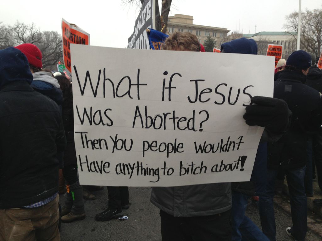 A protest sign that says: What if Jesus was aborted? Then you people wouldn't have anything to B***H about!