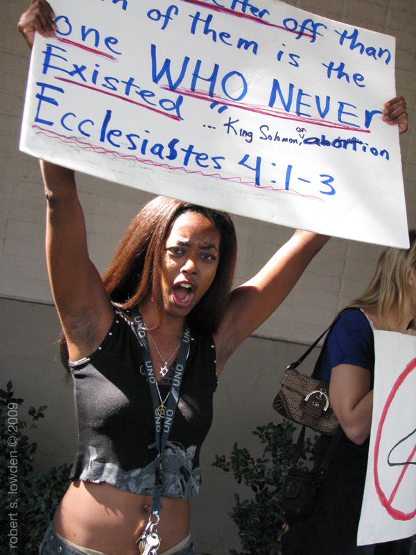 Pro-Choice protestor, Sign shows bible verse Ecclesiastes 4:1-3