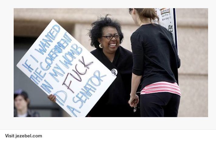 A photo from Jezebel.com of a female holding a sign that says: If I wanted the government in my womb id F**K a senator