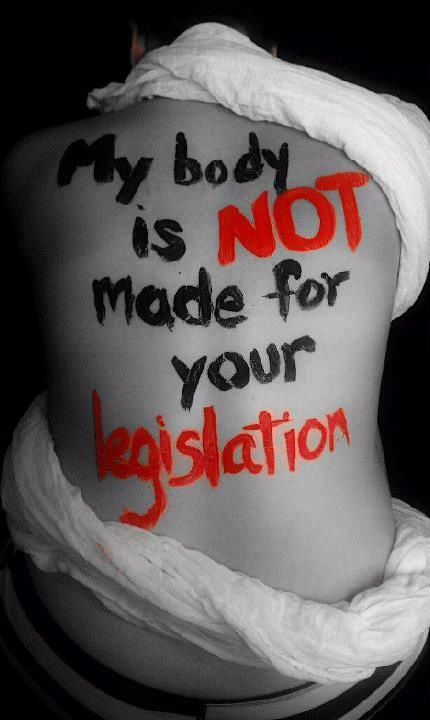 A photo of a bare back with the writing: My body is NOT made for you Legislation
