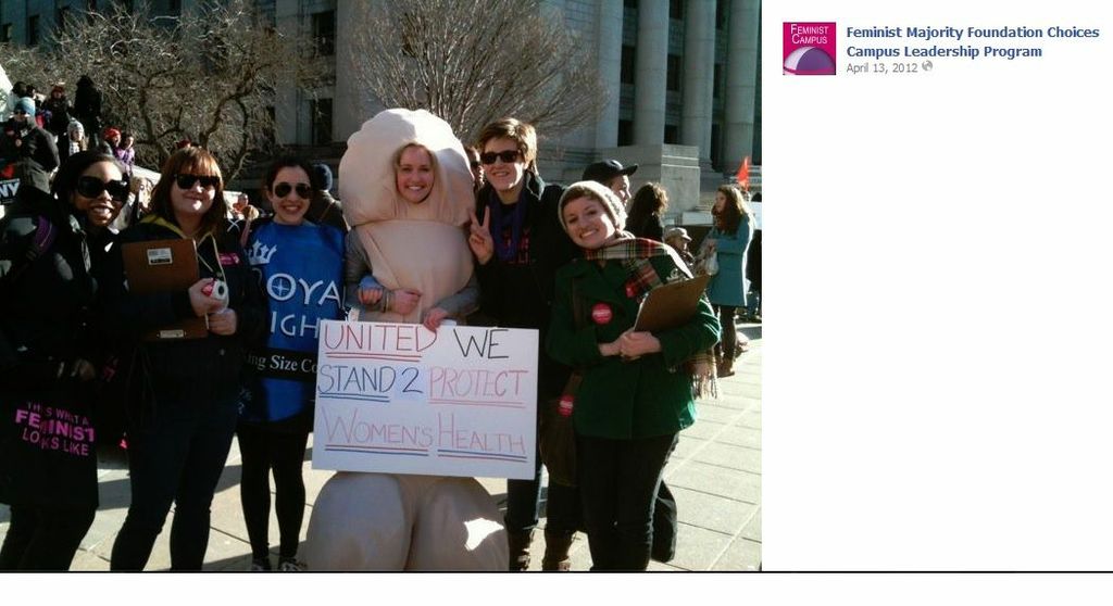 A photo from the Feminist Majority Foundation of a group of protester posing for the camera, but one of them is in a penis costume holding a sign that says: United we stand 2 protect women's health