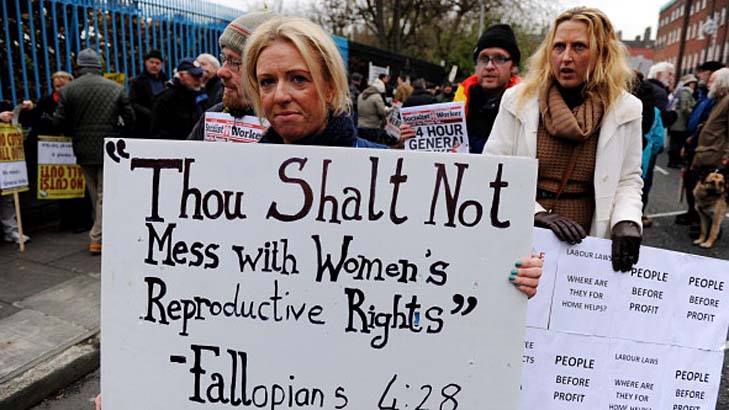 A female protester with a sign that says: "Thou shall not mess with women's reproductive rights" - Fallopians 4:28