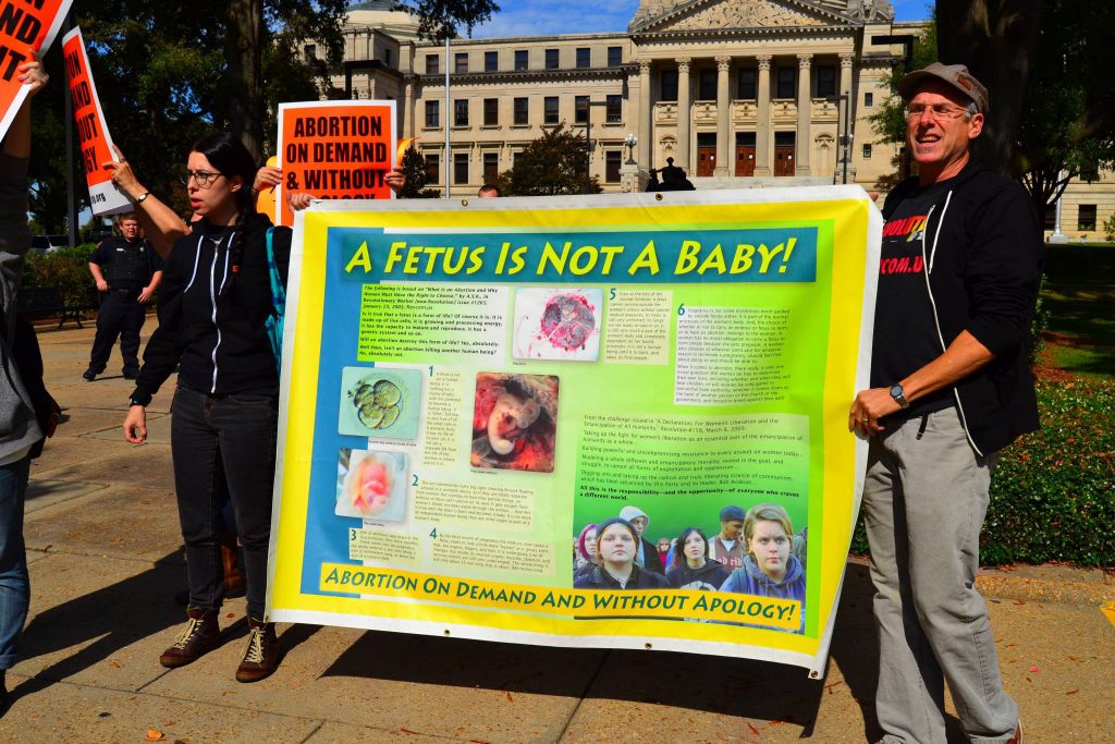 The group Stop Patriarchy are out protesting with a banner that says A fetus is not a baby