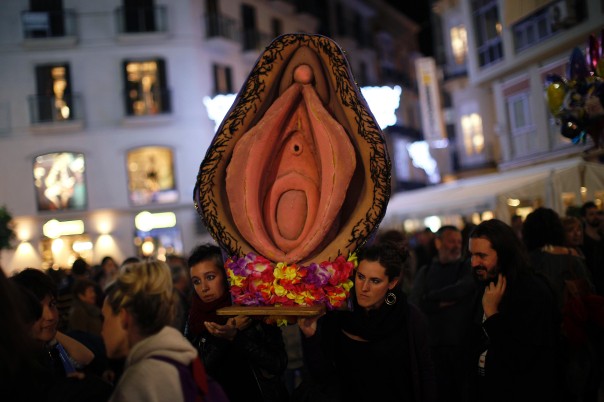 A photo from an abortion protest in Spain with women carrying a giant vagina sculpture