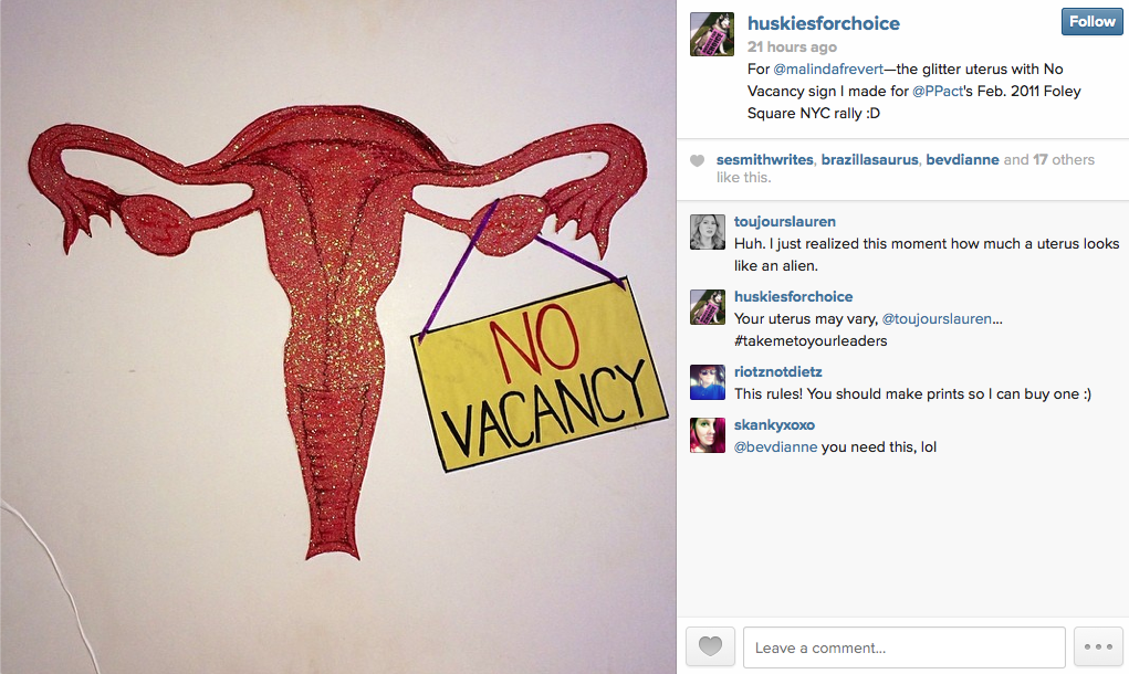 Huskies For Choice posted a photo of a giant female reproductive system that is red with sparkles and its holding a No Vacancy sign