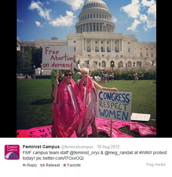 Feminist Campus on twitter posted a photo of two women in vagina costumes holding signs in front of Congress that say: Free Abortion On Demand and Congress-Respect Women