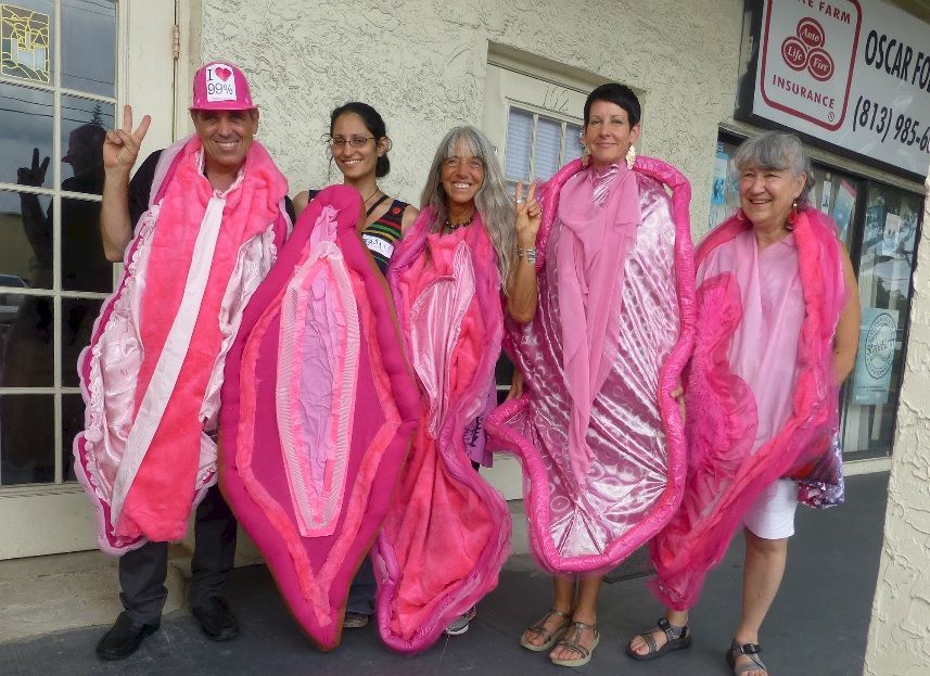 A photo of Code Pink protesters in bright pink vagina costumes