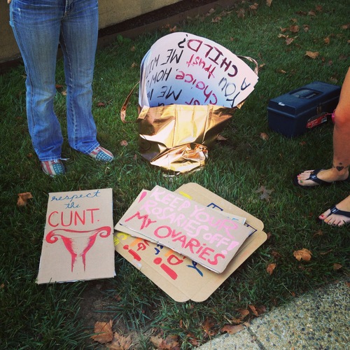 A bunch of different pro-choice posters and some of them say: Respect the C**T, Keep your rosaries off my ovaries!