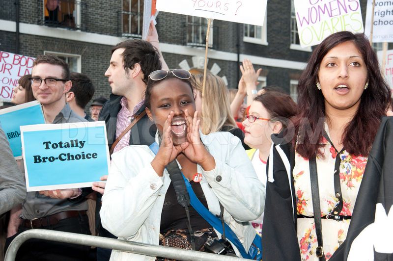 A picture of an abortion rally where men are holding signs saying: Totally Bro-Choice
