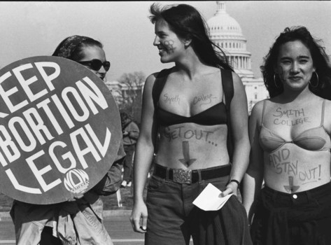 Protest picture of two femal Smith College students outside in their bras with Keep abortion legal NOW sign