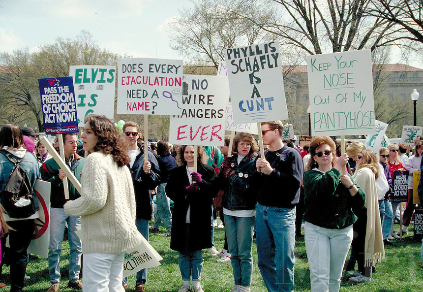A picture of a pro-choice rally with some nasty signs that say: Phyllis Schafly is a C**T, Keep your nose out of my pantyhose, Does every ejaculation need a name?