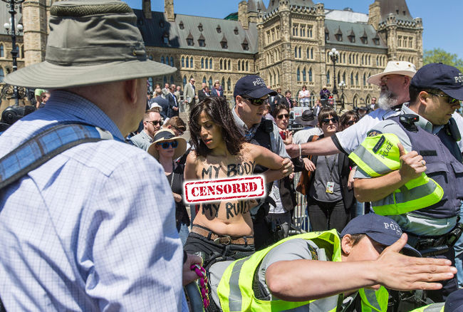 A picture of a topless female protester at the March for Life in Canada