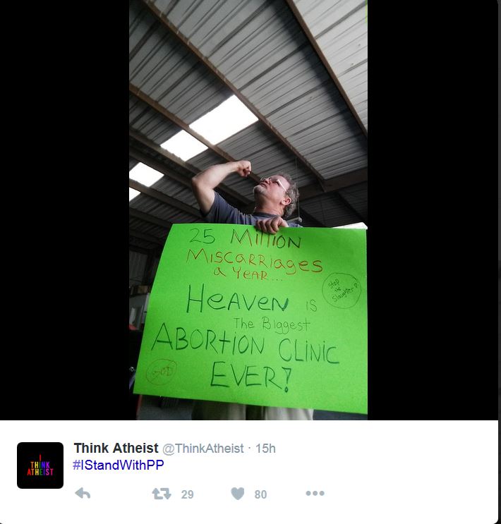 Man proudly holds up sign which reads, "25 million miscarriages a year...Heaven is the biggest abortion clinic ever! Stop the slaughter!" Caption reads, "#IStandWIthPP"