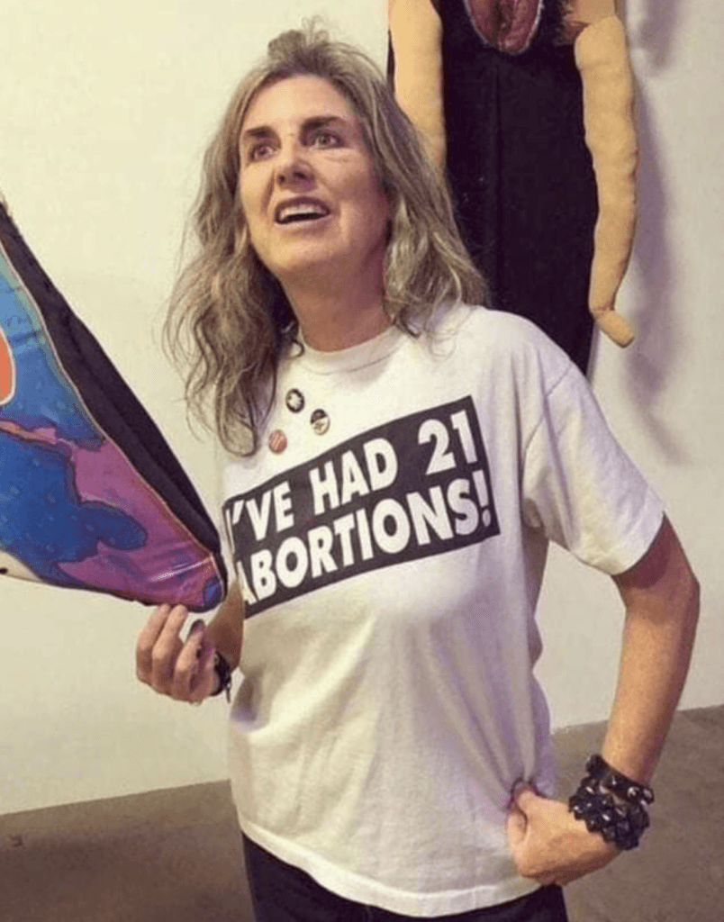 Woman wears a t-shirt which says "I've had 21 abortions!"